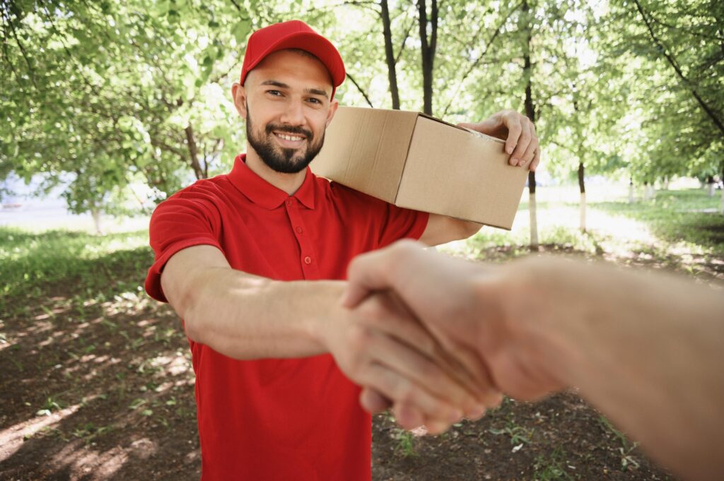 portrait delivery man shaking hand with customer scaled.jpg